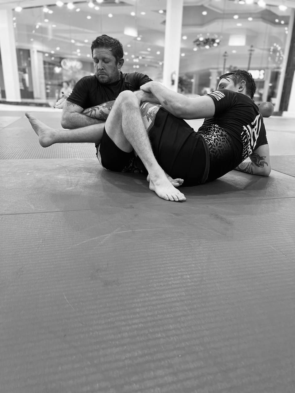 Two competitors working a grappling exchange on the mats